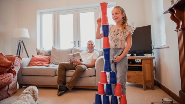 girl playing the stacking cup minute to win it game