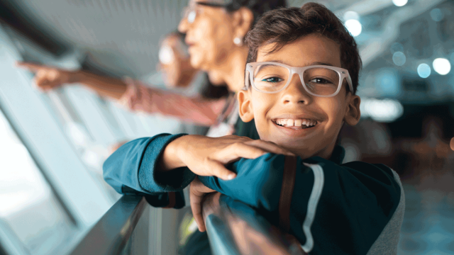 boy wearing glasses at the airport