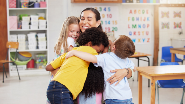 teacher hugging students
