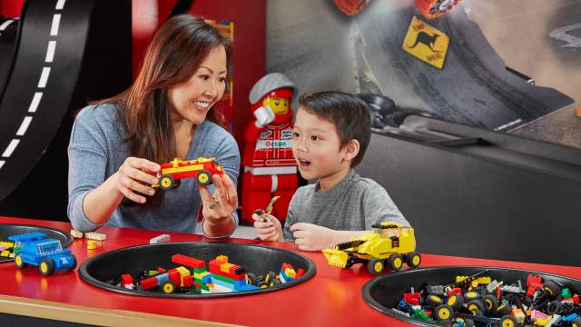 A mother and son play with LEGOs at LEGOLAND Discovery Center Boston