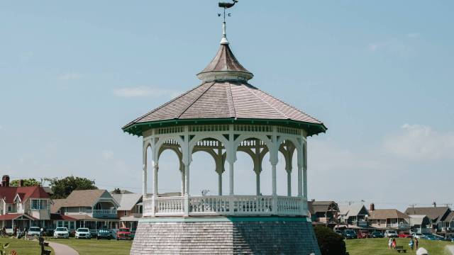 A gazebo on Martha's vineyard with houses in the background