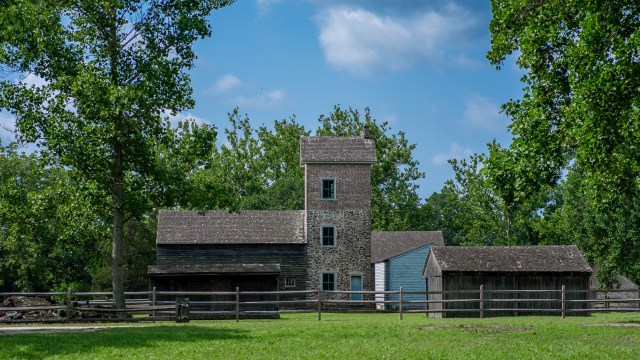 Ghost town scene with restored structures located in green meadows