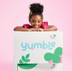 little girl leaning on Yumble box