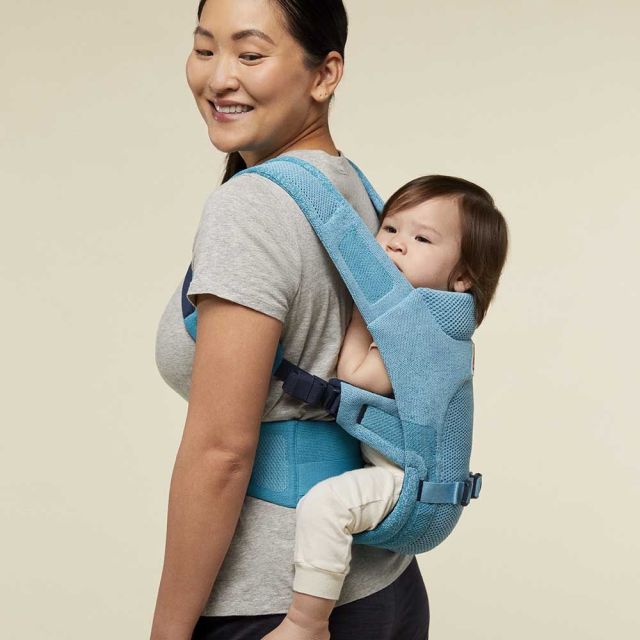 Woman carrying baby in back carrier