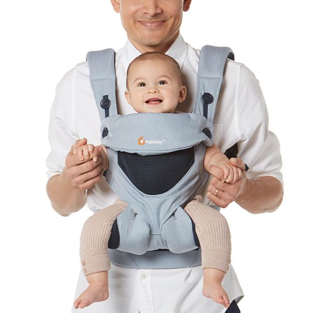 Man carrying baby in front facing carrier