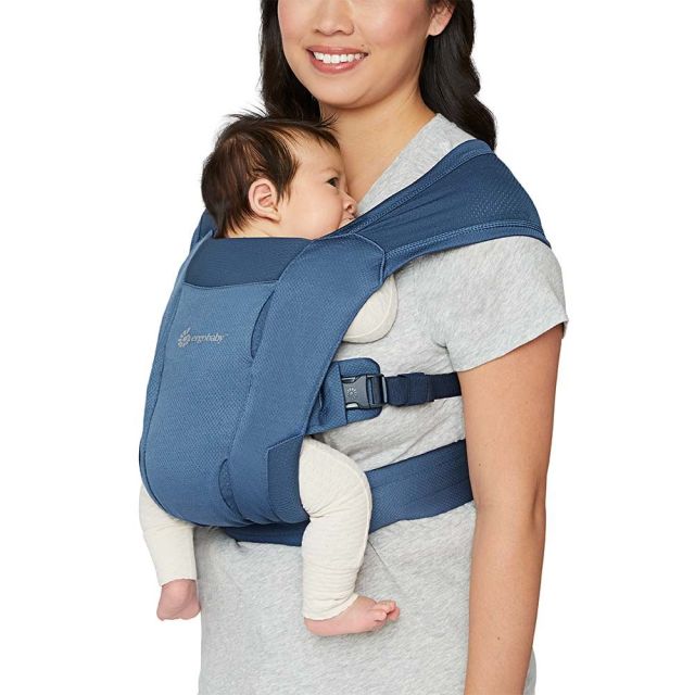 Woman carrying infant in baby carrier