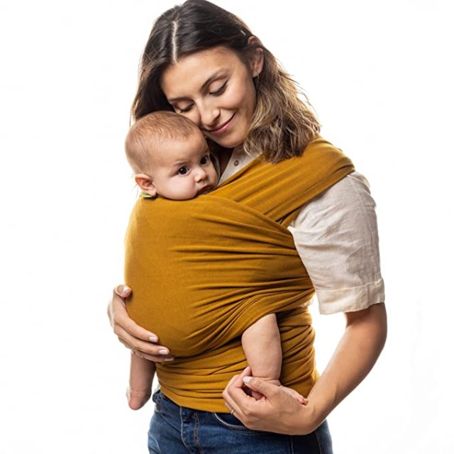 woman holding baby in baby wrap