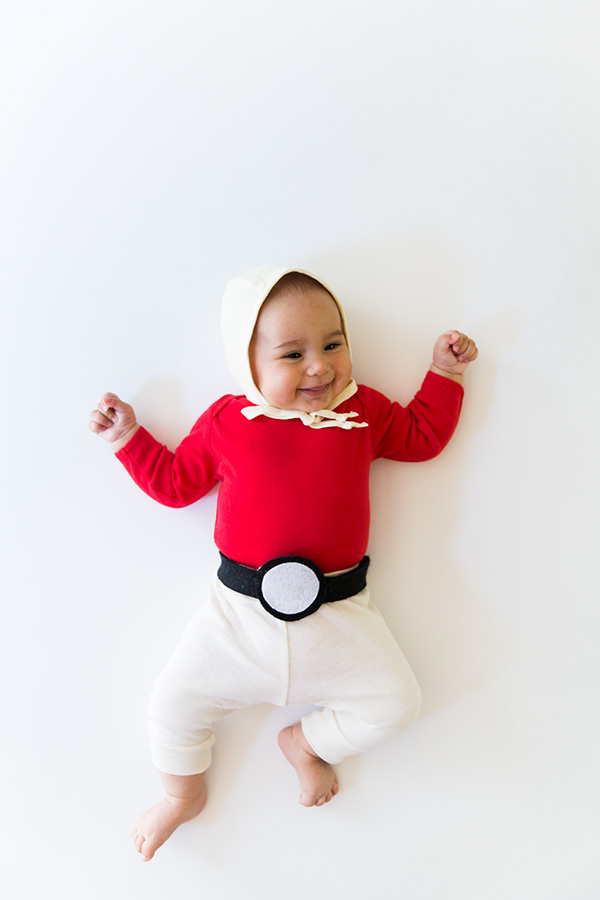 a baby dressed as a poke ball for a roundup of easy costumes you can make with a onesie