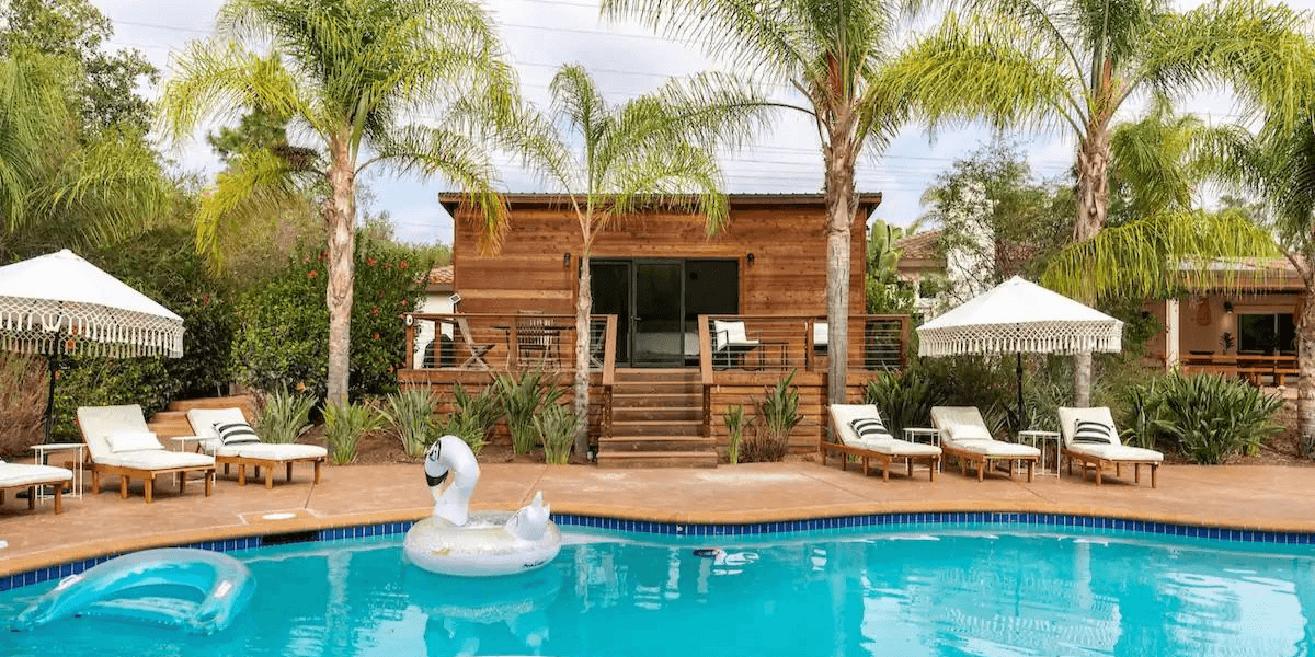 Jacuzzi and pool includes 6 chaise lounge chairs and umbrellas on an outside deck.