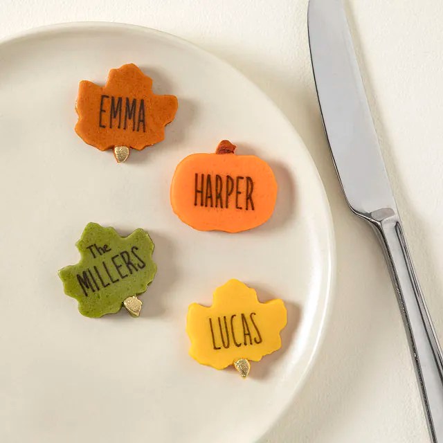 Set of fall-shaped marzipan setting tags on a plate