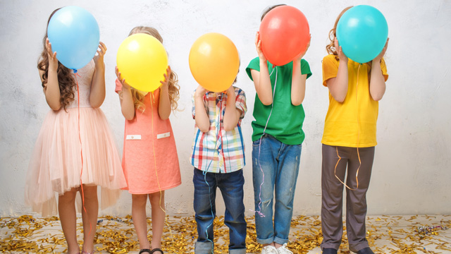 kids holding balloons and telling birthday jokes