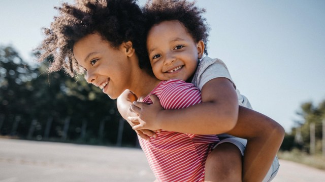 two kids smiling, raising a brave kid