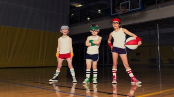 80s kids standing with a basketball
