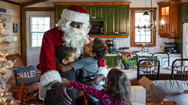 Black Santa Claus hugging children