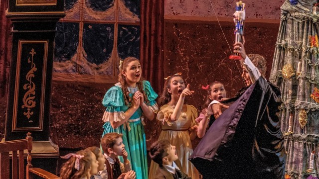 excited kids gather round as the Nutcracker is held aloft during a ballet shows in seattle