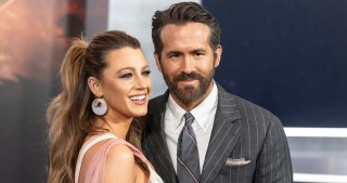 Blake Lively and Ryan Reynolds pose together on a red carpet.