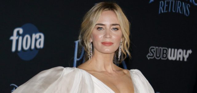 Emily Blunt poses at a press event
