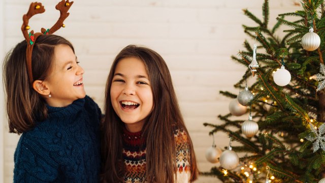 two girls laughing at christmas jokes, santa jokes, elf jokes and snowman jokes