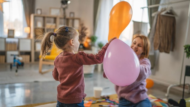 a mom and daughter playing one of our favorite indoor games with balloons
