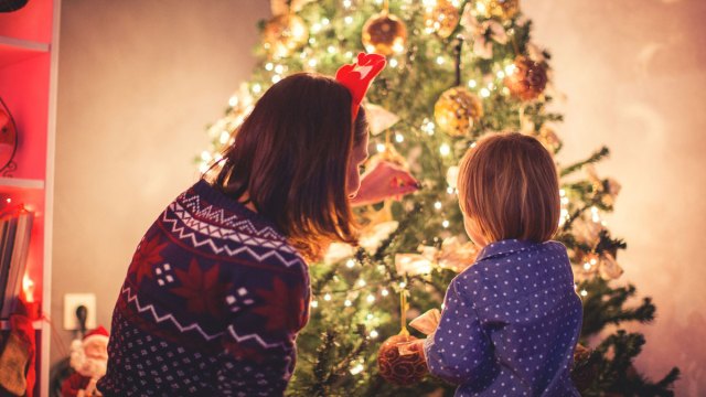 mom and child looking at a Christmas tree