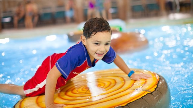 a boy on a float at a portland water park great wolf lodge an unbelievale indoor swimming pool