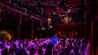 violinist in a an aerial swing during teatro zinzanni in seattle