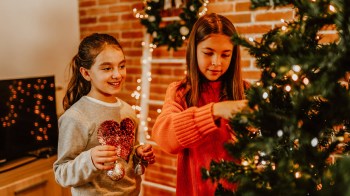 girls decorating Christmas tree
