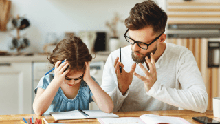 Dad helping daughter with homework
