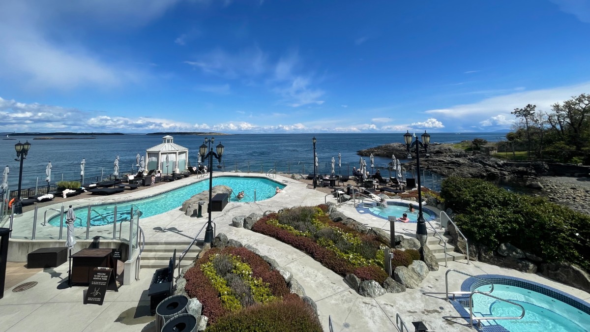 a gazebo and pools overlook the water at a girls weekend trips from seattle resort in victoria bc