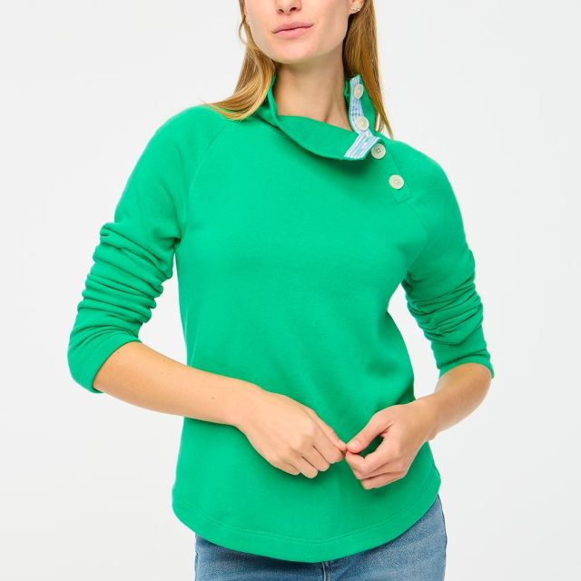 woman wearing green pullover and jeans