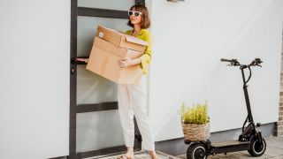 woman carrying delivery packages inside