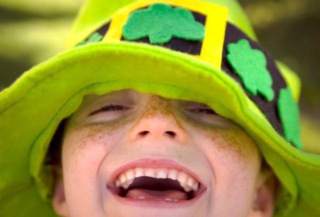 A boy laughing at St Patrick's day jokes. 