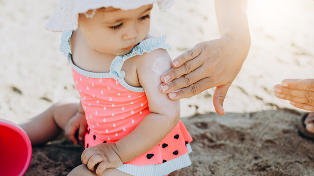 mom using baby beach hack by chilling sunscreen