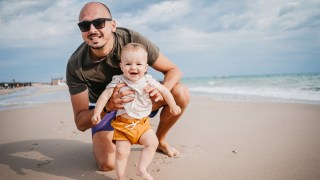 dad with baby at the beach needs to know some baby beach hacks