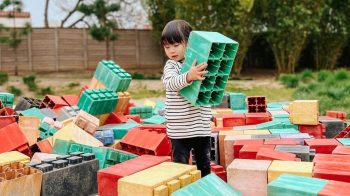 little girl playing with building blocks at Los Angeles area Adventure Playground in Irvine