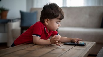 toddler asking ChatGPT questions on an iphone