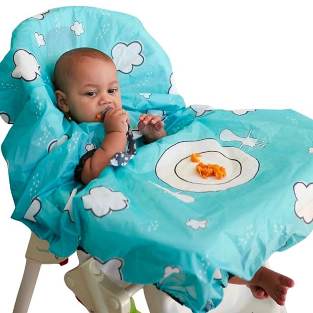 baby in highchair wearing all-over bib