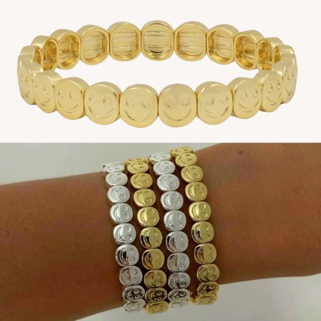 silver and gold stretch beaded smiley face bracelets stacked on arm