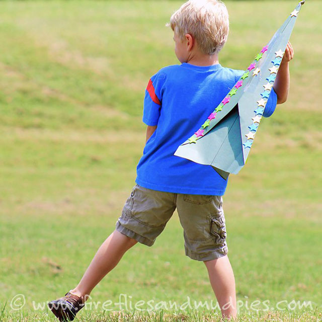 kid throwing a giant paper airplane