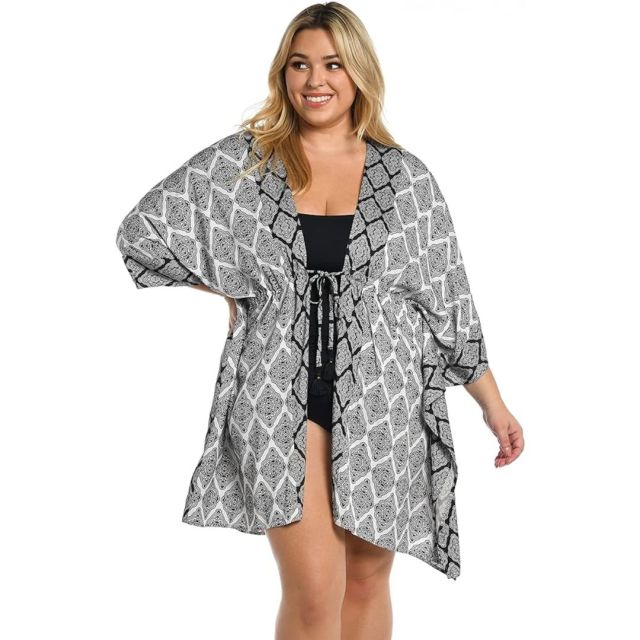 woman wearing black and white robe-style swimsuit coverup