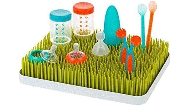 colorful blue and orange bottles and nipples on a grass drying rack, must have baby gear