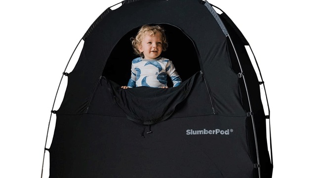 if you travel, must have baby gear includes a babypod, black tent with a boy in pajamas peering out 