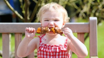 a girl eats a kabob, a quick and easy toddler lunch idea