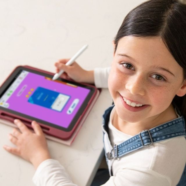 elementary-aged child using an educational tablet