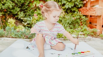 toddler making outdoor art