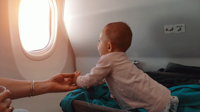baby in an airplane bassinet on family trip