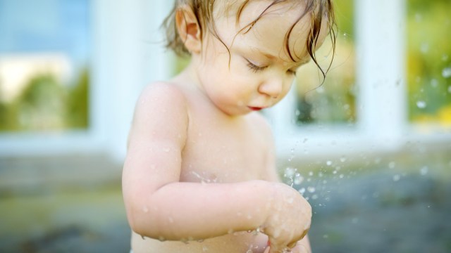 a toddler playing with the hose for a story on hose water burns