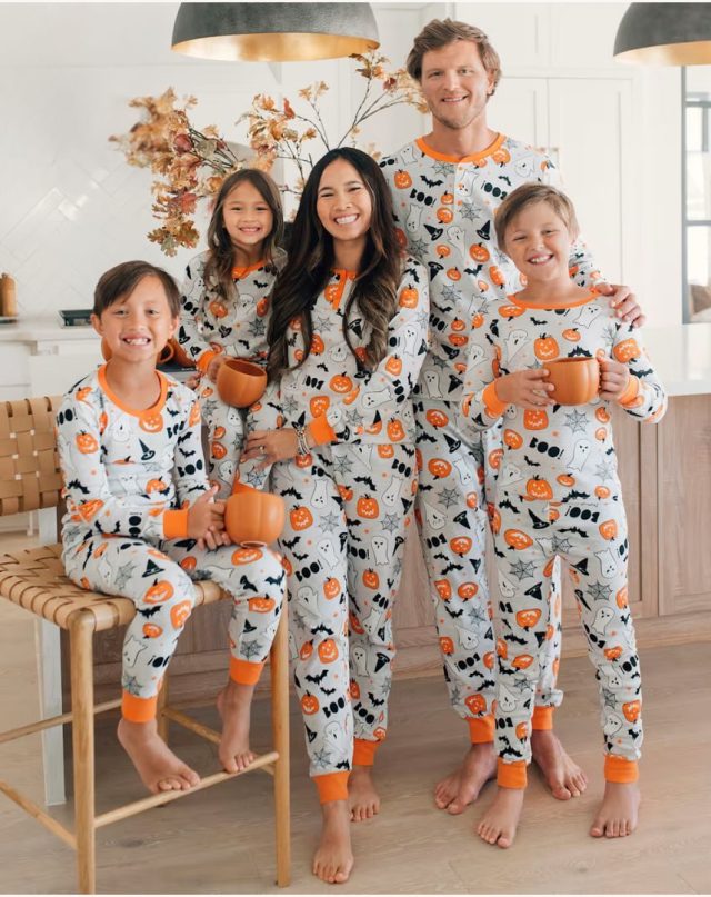 family standing in kitchen wearing halloween pajamas