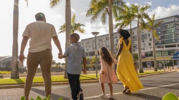 family walking by palm trees in Puerto Rico