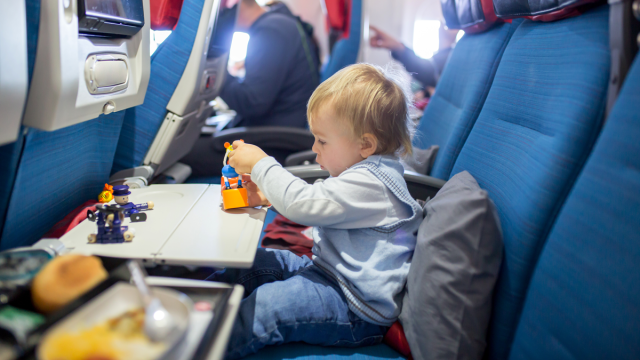 toddler playing on an airplane